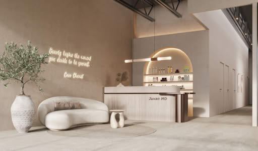 Minimalist beauty salon lounge with curved sofa, decorative plant, illuminated Coco Chanel quote, and modern reception counter.