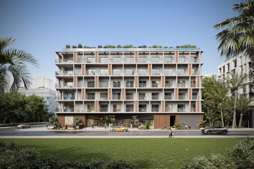 Modern apartment building with balconies and palm trees in Jumeirah Village Triangle.