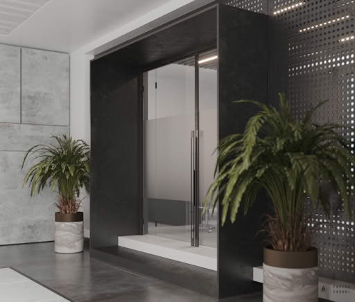 Stylish office hallway with glass conference room entrance, black frame, perforated metal wall panels, and indoor plants.