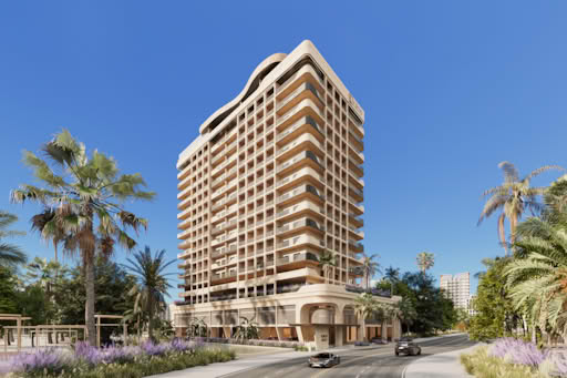 A modern residential building with balconies and palm trees in front.