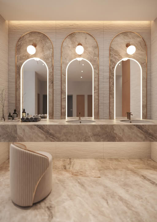 A luxurious bathroom with three arched mirrors and marble surfaces.